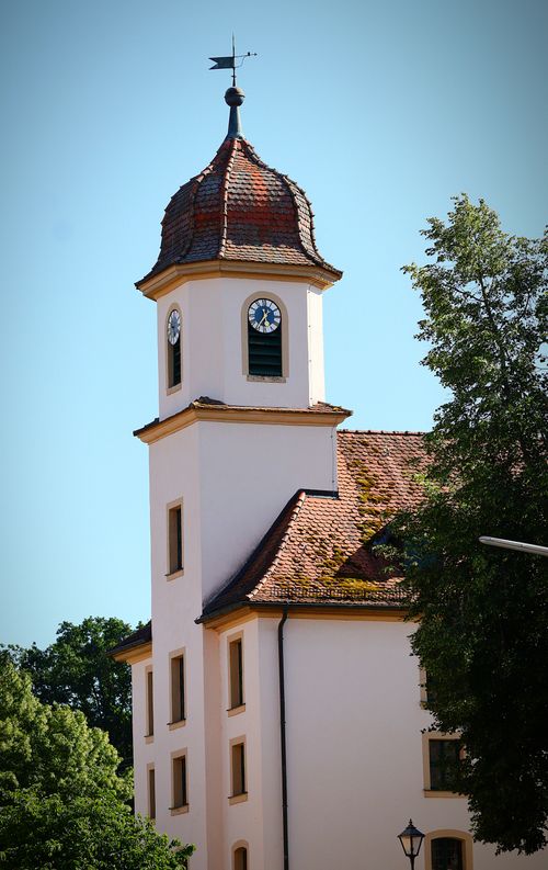 Free Historic clock tower with unique red roof against clear blue sky. Stock Photo