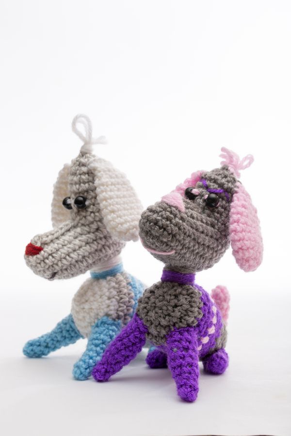 Two crocheted dog-shaped toys side by side