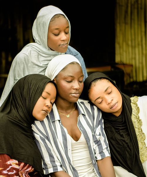 Free A touching moment capturing four young women in hijabs sharing a calm and intimate embrace, symbolizing unity. Stock Photo