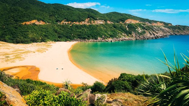 Stunning coastal view of a sandy beach and turquoise waters in Hòa Xuân, Đắk Lắk.