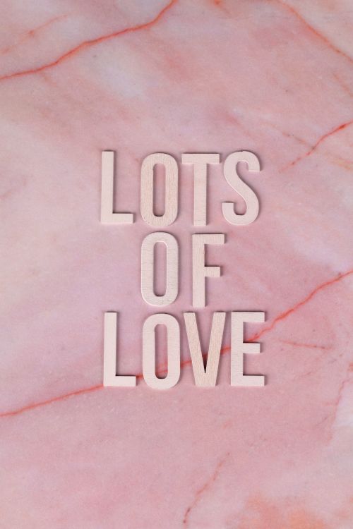 Free Elegant pink marble background with 'Lots of Love' message in wooden letters, perfect for romantic designs. Stock Photo