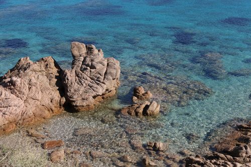Free Pristine coastal rock formations set in clear blue waters under a bright sunny sky. Stock Photo