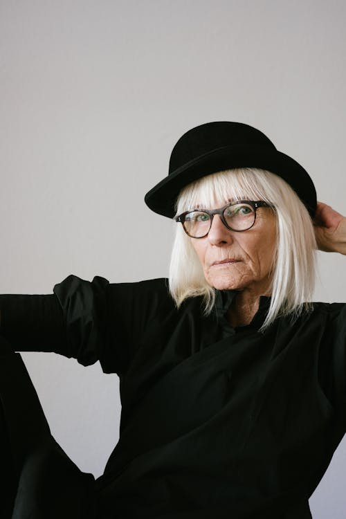 Woman in Black Long Sleeve Top Wearing Black Hat