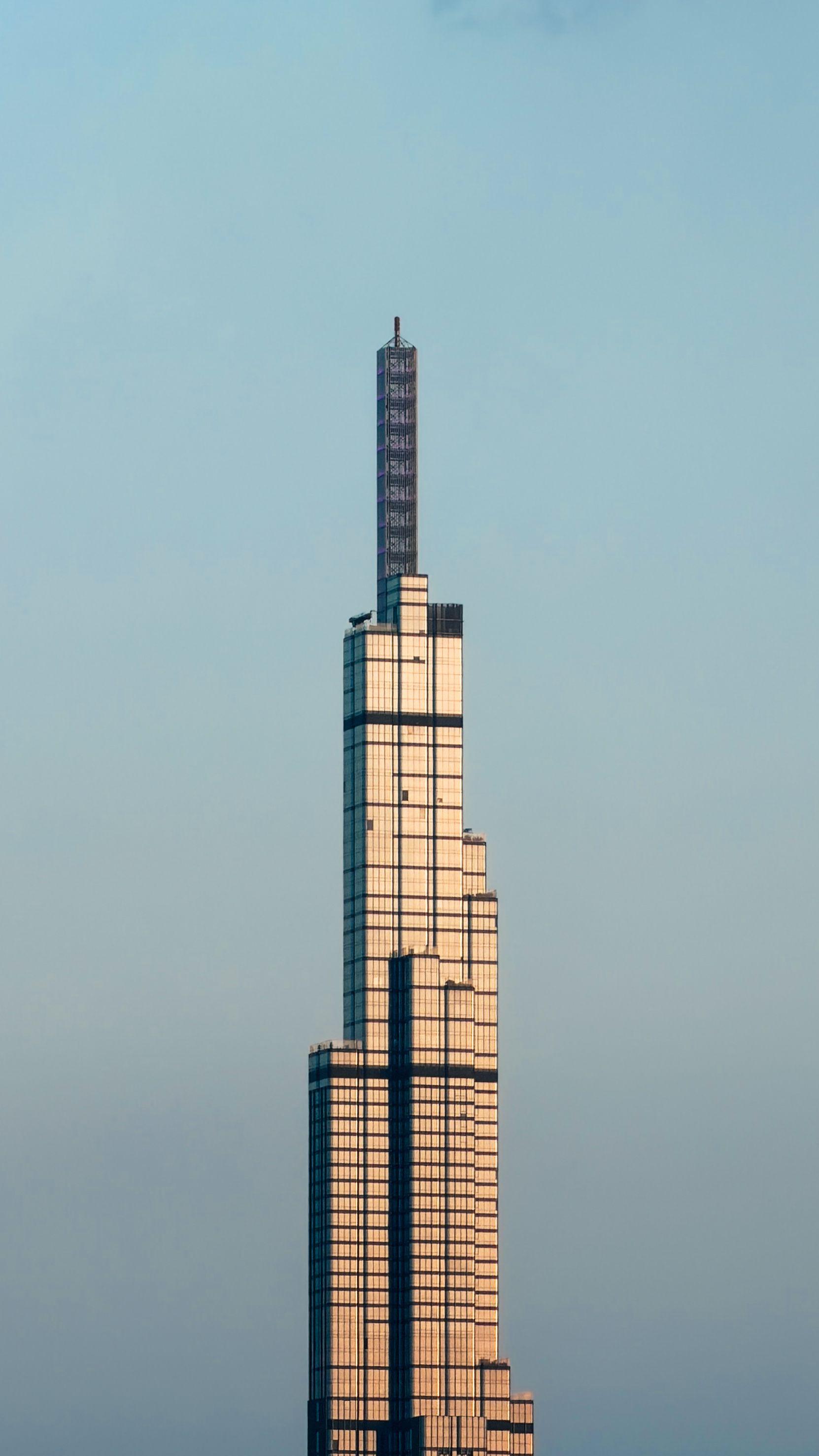 Towering Landmark 81 in Ho Chi Minh City against a clear blue sky, showcasing modern architecture.