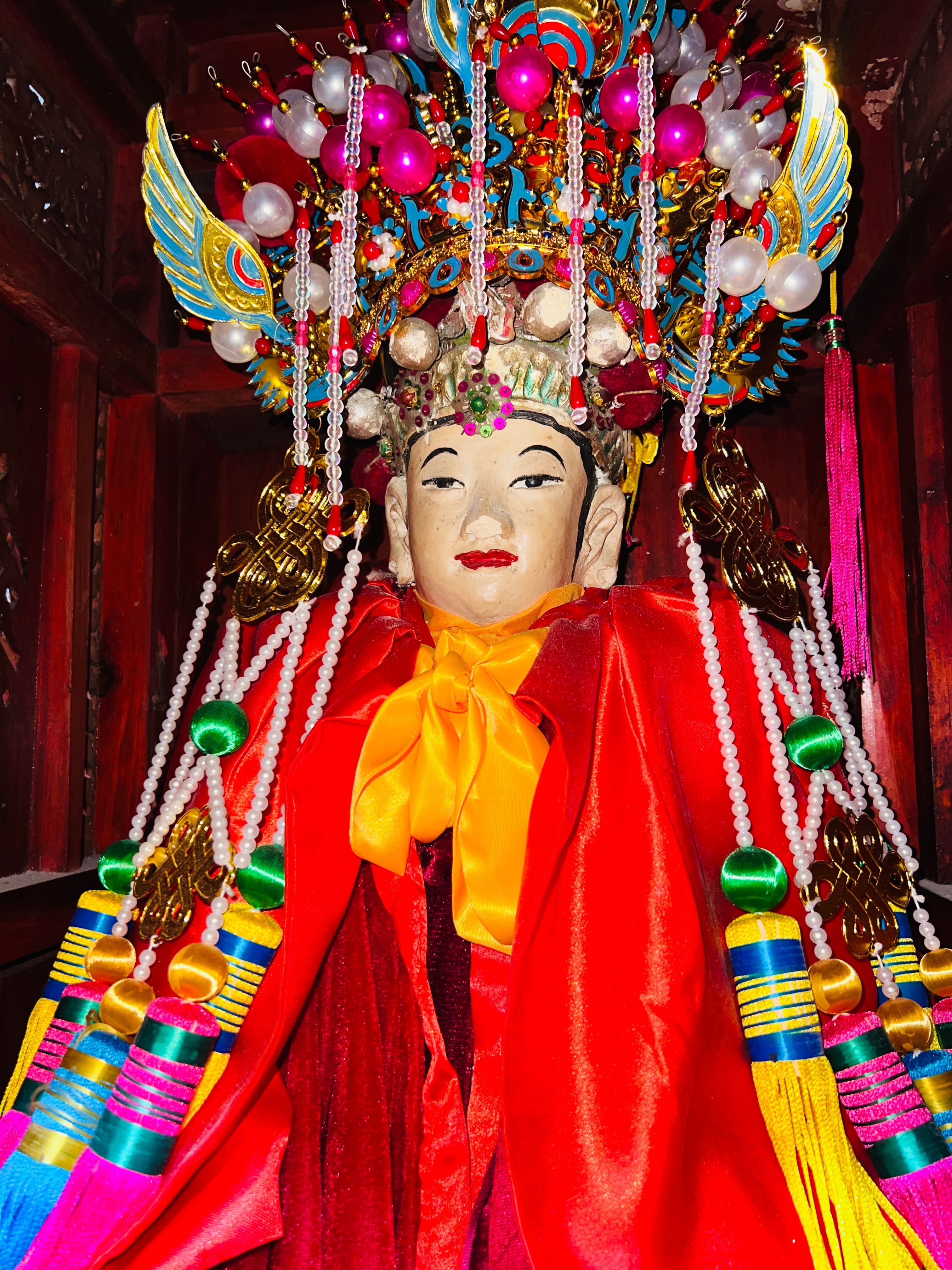Vibrant traditional Chinese statue adorned with intricate ornaments, symbolizing cultural heritage and artistry.