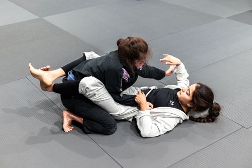 Free Two women engaging in jiu-jitsu practice on training mats in Buenos Aires, Argentina. Stock Photo