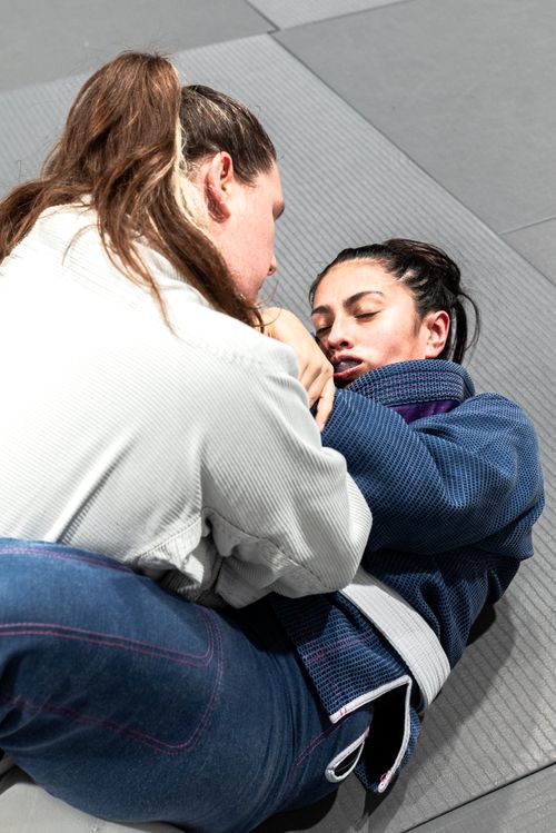 Free Two women engaging in Brazilian Jiu-Jitsu training on a mat in Buenos Aires, Argentina. Stock Photo