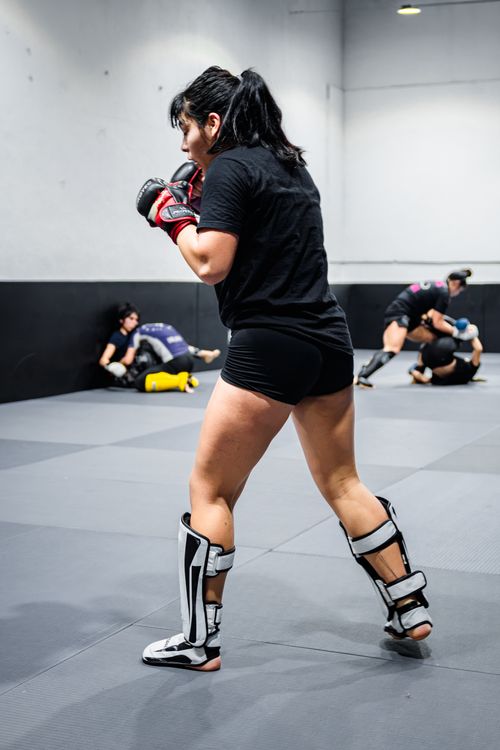 Free Martial arts training session with athletes practicing in Buenos Aires gym, focusing on MMA techniques. Stock Photo