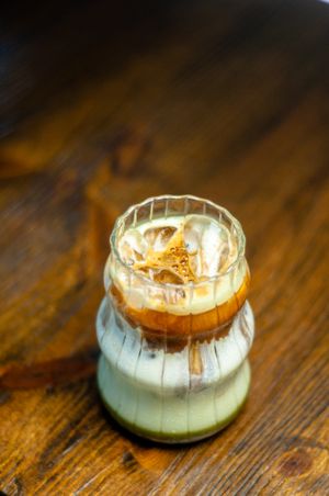Layered iced coffee in a ribbed glass — photo by Edward Rye Espiritu on Pexels