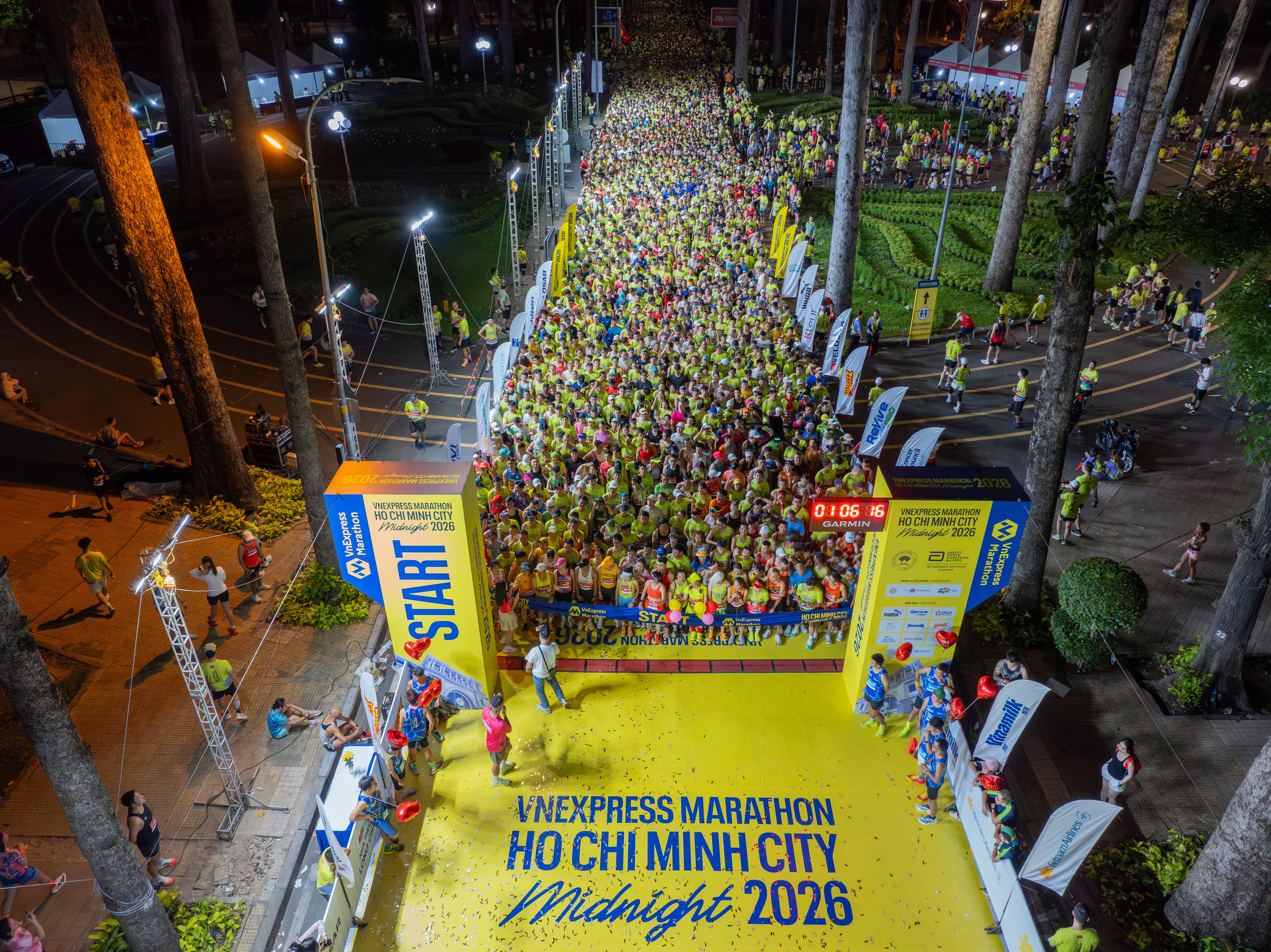 Aerial view of the bustling midnight marathon in Ho Chi Minh City, full of runners and energy.