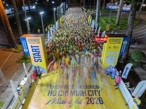 Free Vibrant nighttime marathon starting with a large crowd in Ho Chi Minh City. Stock Photo
