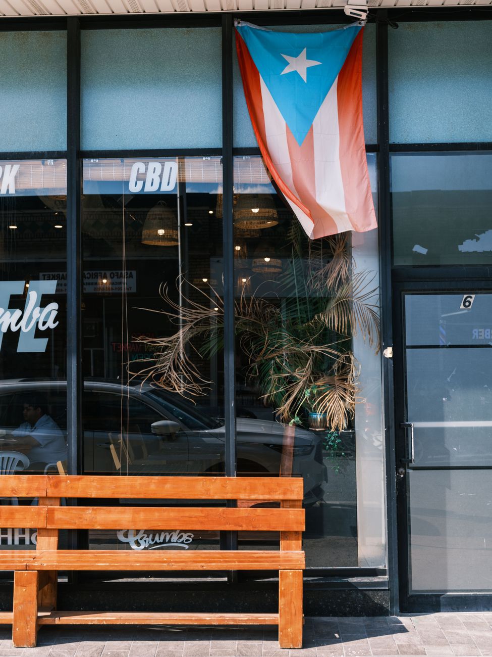 Puerto Rican flag displayed outside a cafe, reflecting cultural pride.