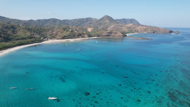 A breathtaking aerial view of the clear turquoise waters and coastline of Lombok, Indonesia. — lounges at Lombok Airport