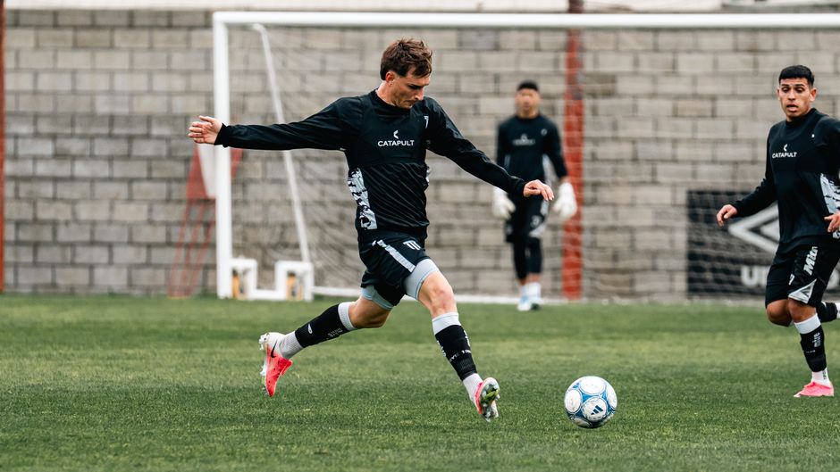 Ruben Neves controlling the ball in a deep-lying playmaker position during a match.