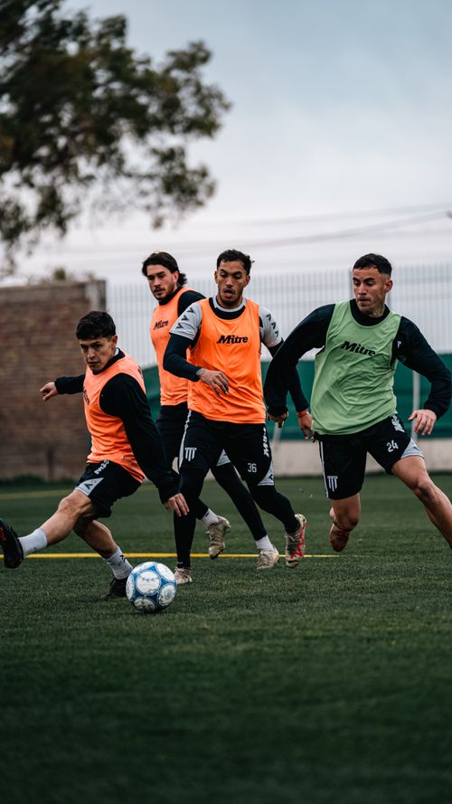 Free A group of young soccer players in training on a green field. Focus on energy and teamwork. Stock Photo