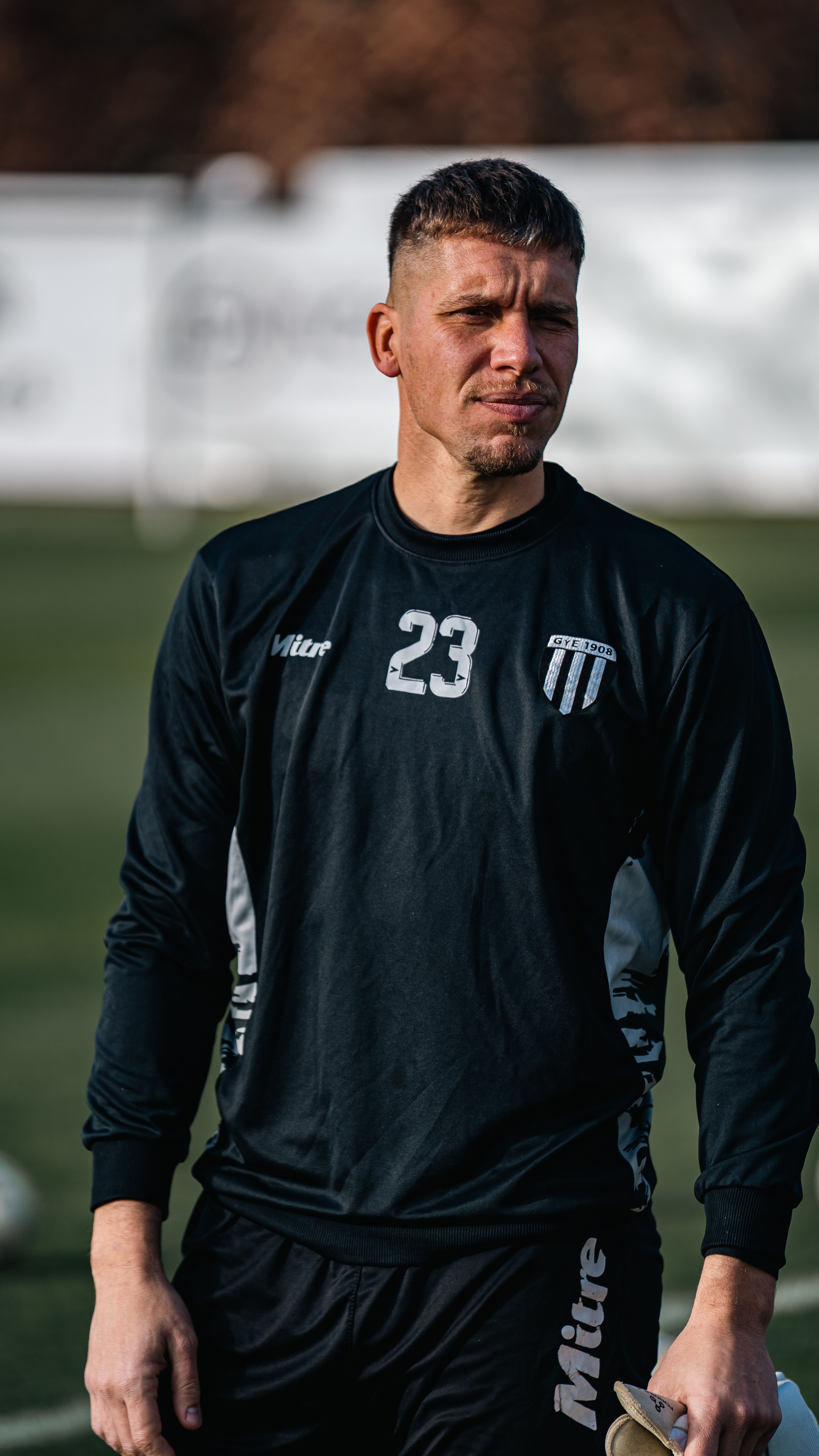Soccer player wearing black sportswear during an outdoor training session.