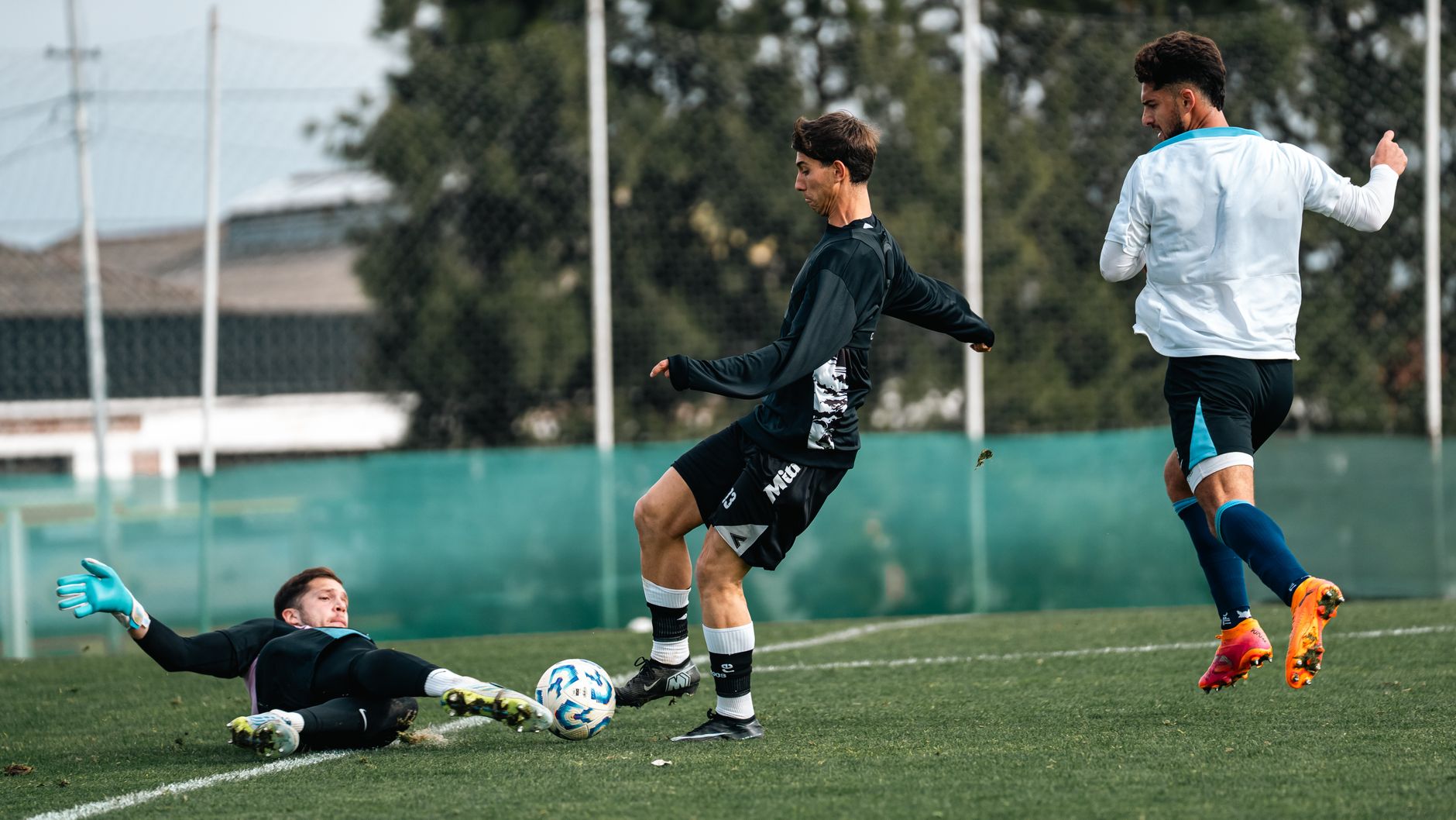 Dramatic soccer match moment with players in action on a grassy field.
