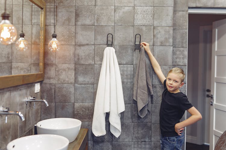 Small Kid Taking Towel In Bathroom