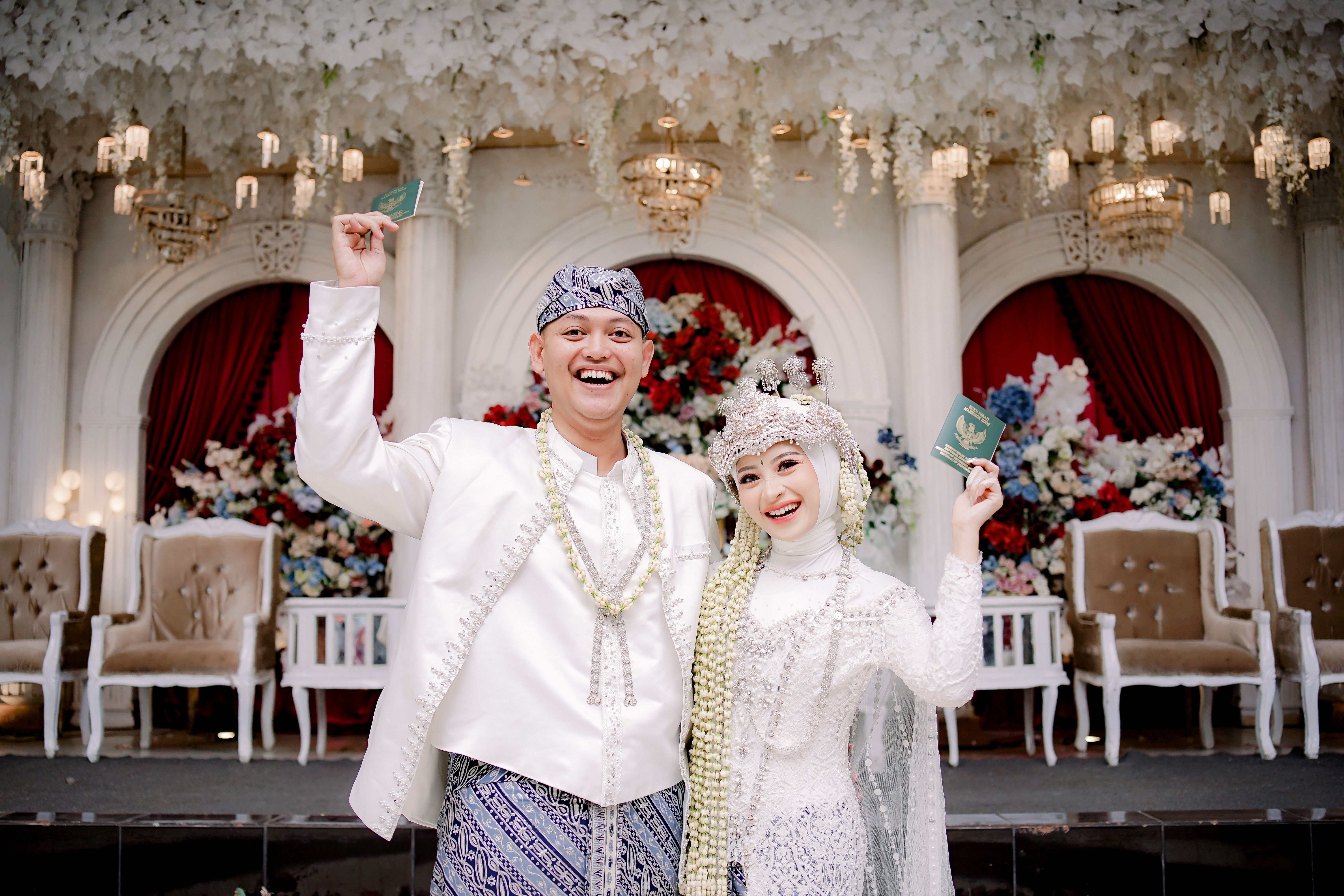 Joyful Sundanese couple celebrates their wedding with traditional attire in Bandung, Indonesia.