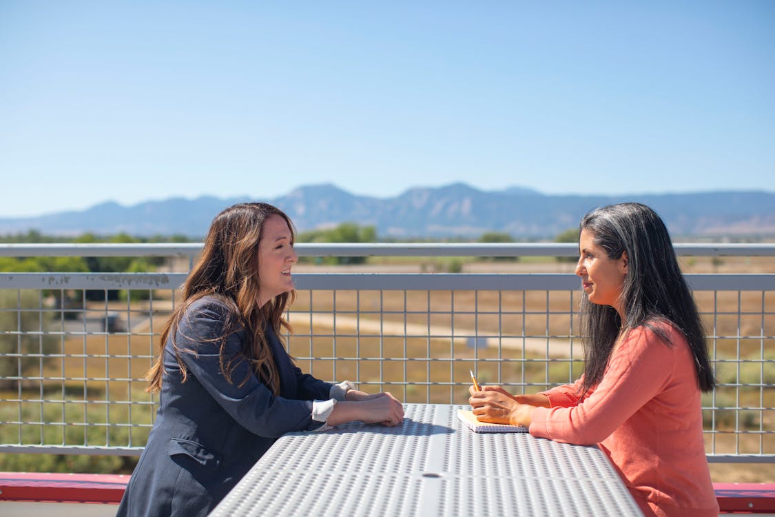 Women Having a Conversation while on the Rooftop