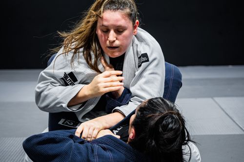Free Two women engage in a Brazilian jiu-jitsu session, displaying technique and focus. Stock Photo
