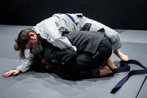 Free Two athletes engage in a Brazilian Jiu-Jitsu practice match, demonstrating skillful grappling techniques. Stock Photo