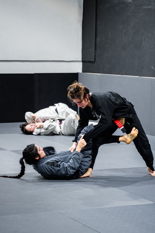 Free Two practitioners engage in intense Brazilian Jiu-Jitsu training session indoors. Stock Photo
