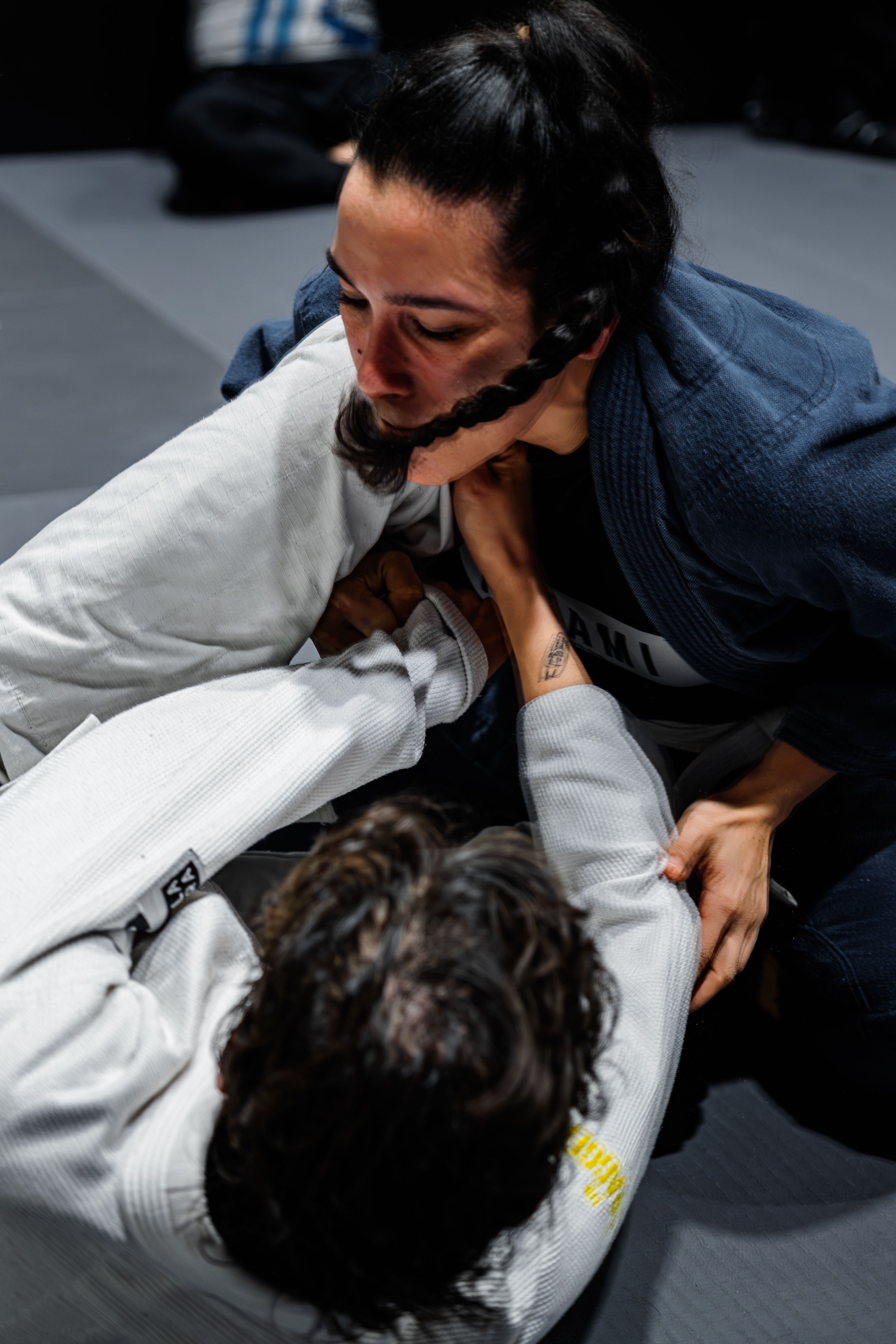 Two athletes engaged in intense Brazilian Jiu-Jitsu practice, showcasing skill and focus.
