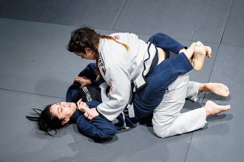 Free Two women engage in a Jiu-Jitsu grappling match on a mat in Buenos Aires, Argentina. Stock Photo