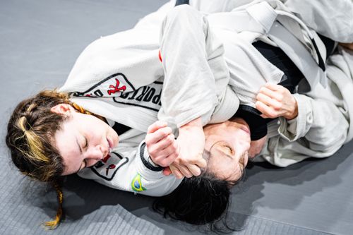 Free Close-up of two women practicing Brazilian Jiu-Jitsu, demonstrating intense grappling techniques. Stock Photo