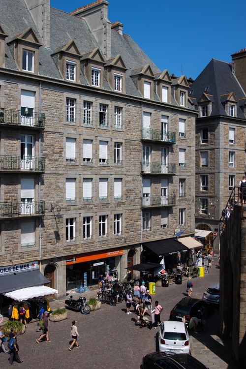 Free Pedestrians and historic architecture in sunny Saint-Malo, France. Stock Photo