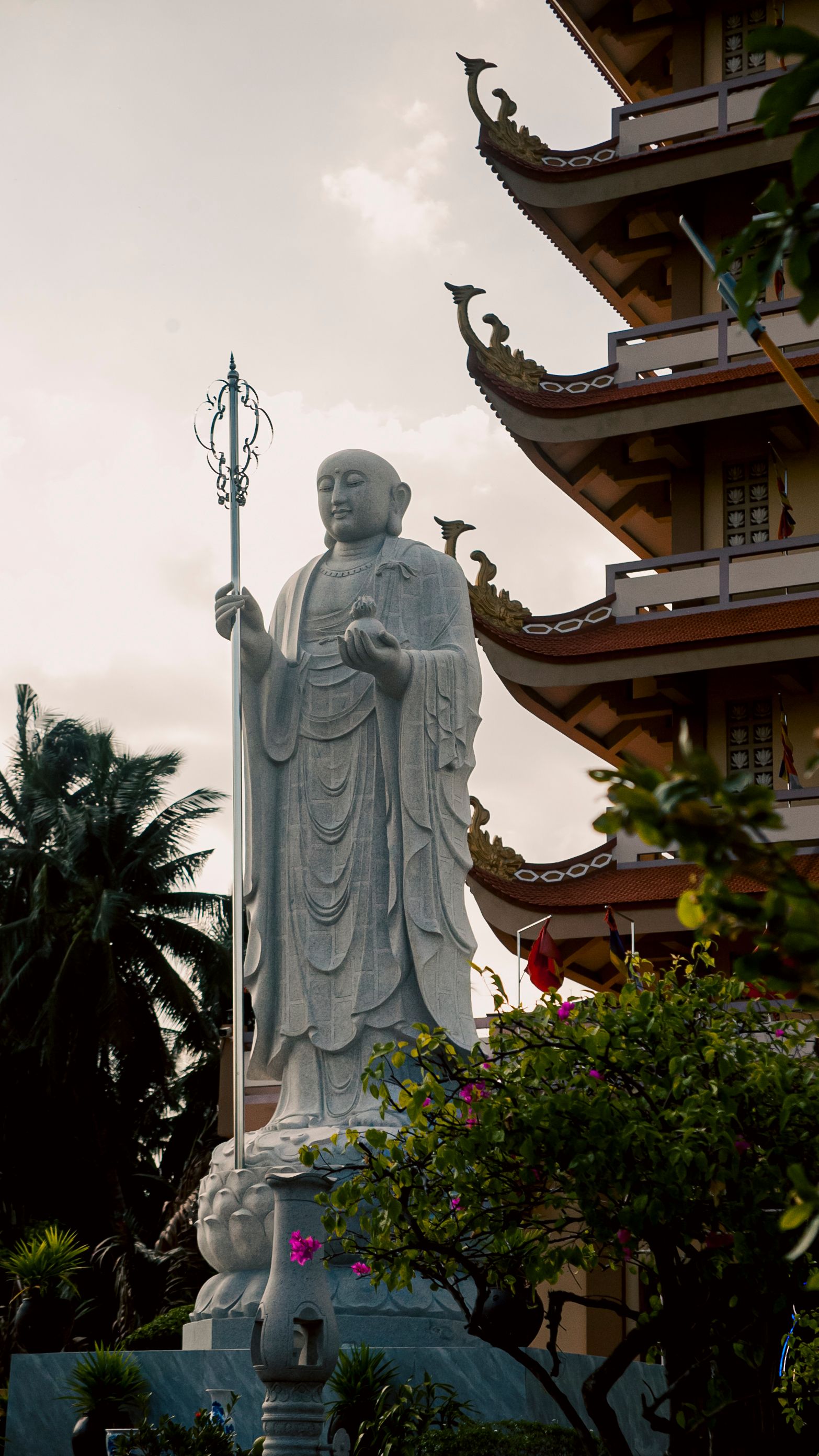 Serene white Buddhist statue at a traditional pagoda in My Phong, Dong Thap, Vietnam.