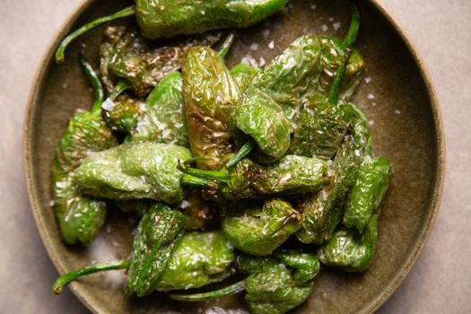 Freshly fried Padron peppers served as traditional Spanish tapas, a perfect appetizer or snack.