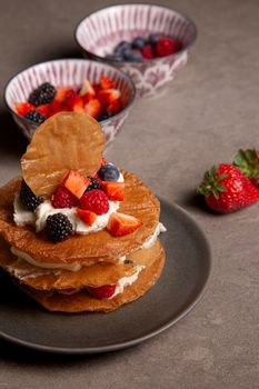 Delicious layered filo dessert with fresh mixed berries and cream.