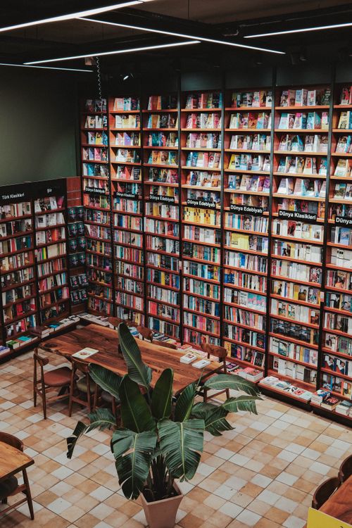 Free Aerial view of a bookstore interior with colorful bookshelves and reading tables. Stock Photo