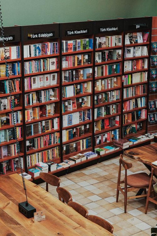 Free A charming bookstore showcasing Turkish literature with wooden shelves and seating area. Stock Photo