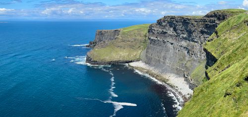 Free Breathtaking view of the Cliffs of Moher with clear blue skies and the Atlantic Ocean. Stock Photo