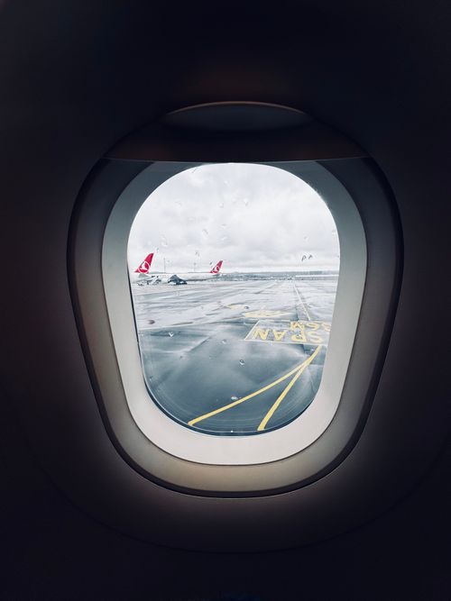 Free View from an airplane window overlooking the rainy runway at Istanbul Airport. Stock Photo