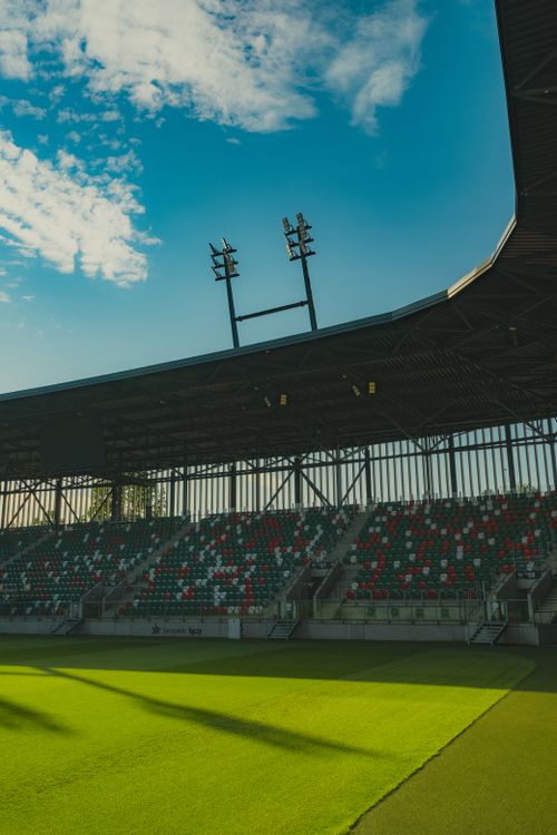 Free Broad daylight view of a sleek sports arena in Sosnowiec, Poland, with vibrant grass and seating. Stock Photo