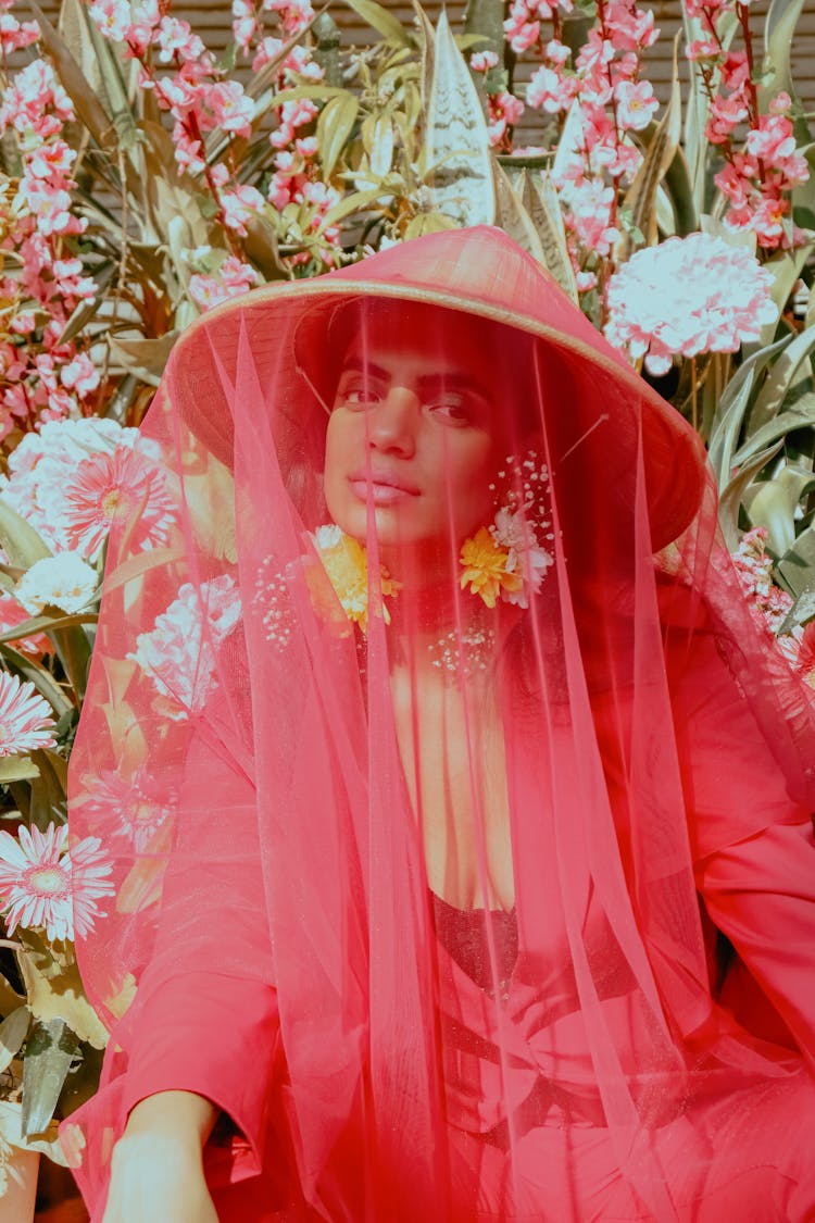 Elegant Ethnic Woman Resting Near Blooming Flowers