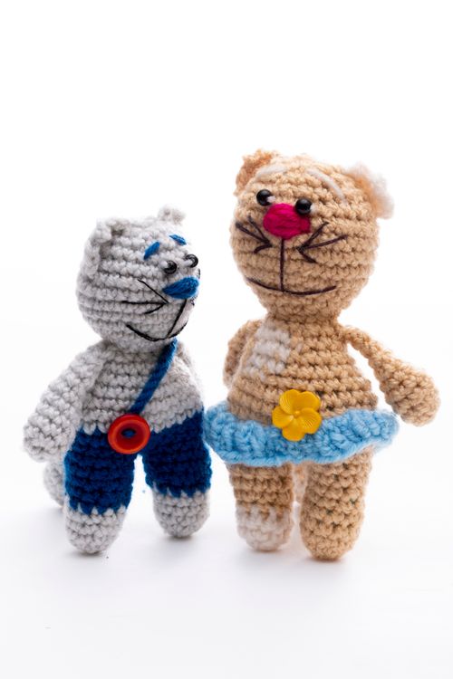 Free Adorable handmade crochet cat dolls with colorful attire on display. Stock Photo