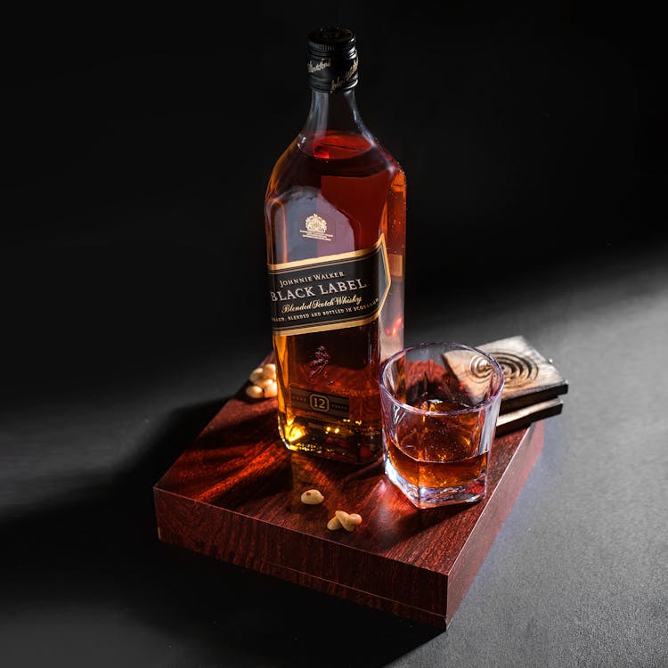 A Bottle Of Black Label On A Wooden Board