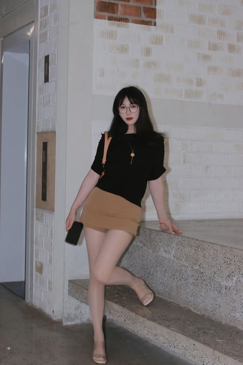 Free Stylish woman in trendy outfit poses confidently in a modern urban environment. Stock Photo