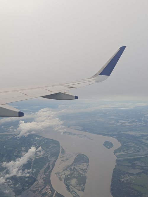 Free Scenic aerial view of a river and landscape from an airplane window. Stock Photo