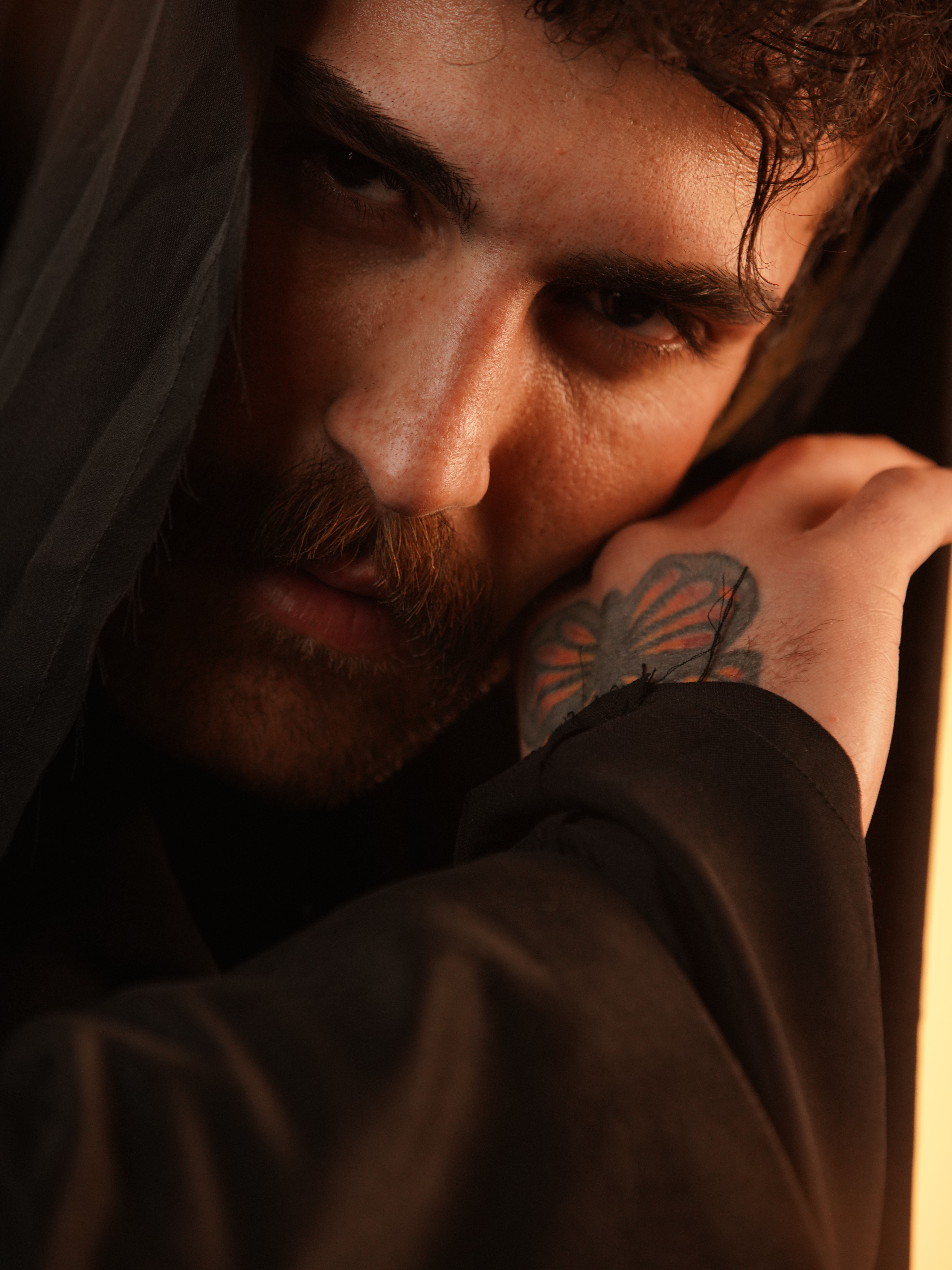 Intense Portrait of a Pensive Man with Tattoo