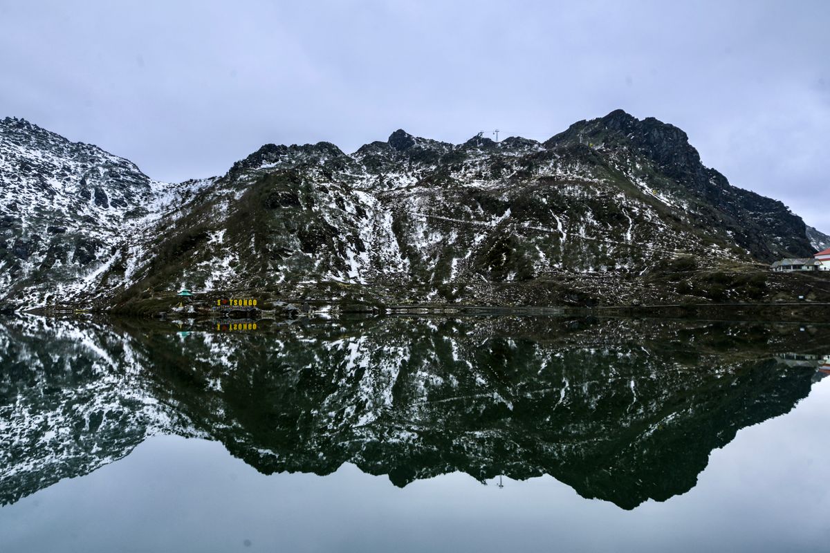 Snow-dusted peaks reflected in Tsomgo Lake, Sikkim