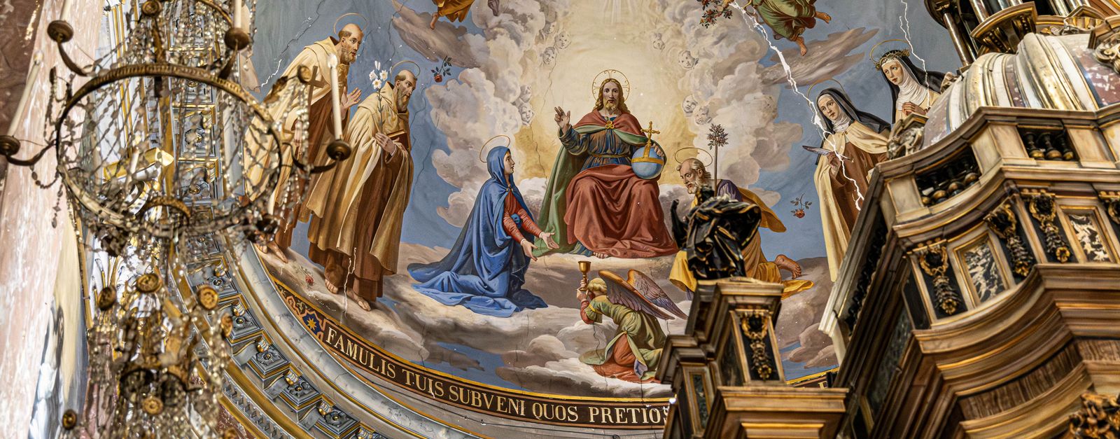 Ornate church ceiling mural with religious figures and detailed architecture.