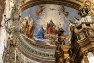 Ornate church ceiling mural with religious figures and detailed architecture.