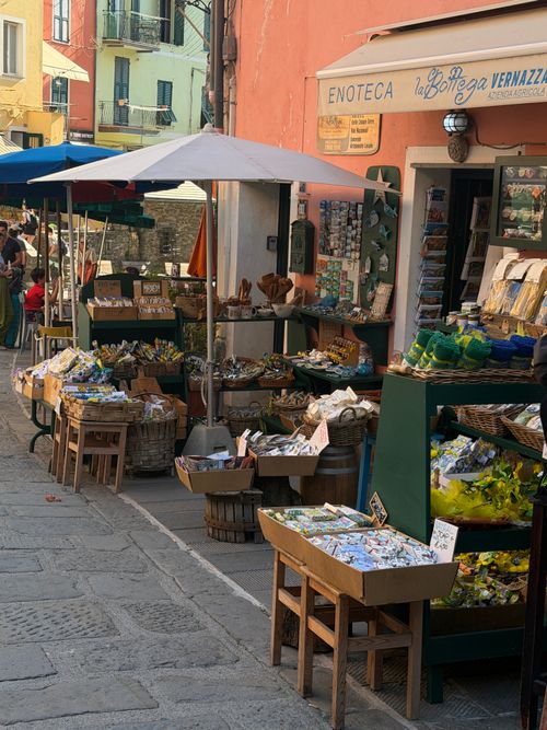 Free Colorful street market in Vernazza with fresh produce and local goods on display under umbrellas. Stock Photo