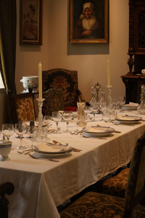 Free Elegant vintage dining table set with crystal glassware and candles in a classic interior. Stock Photo